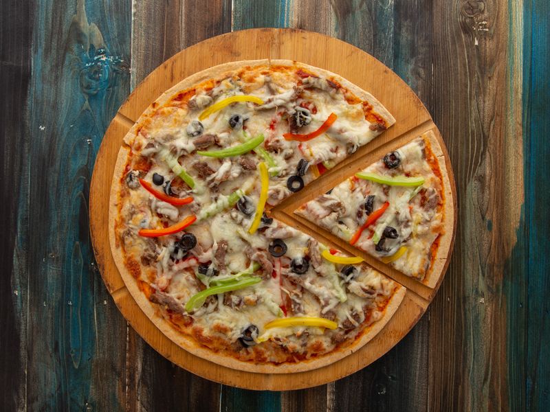Spicy pepperoni mod pizza with chili flakes and honey drizzle