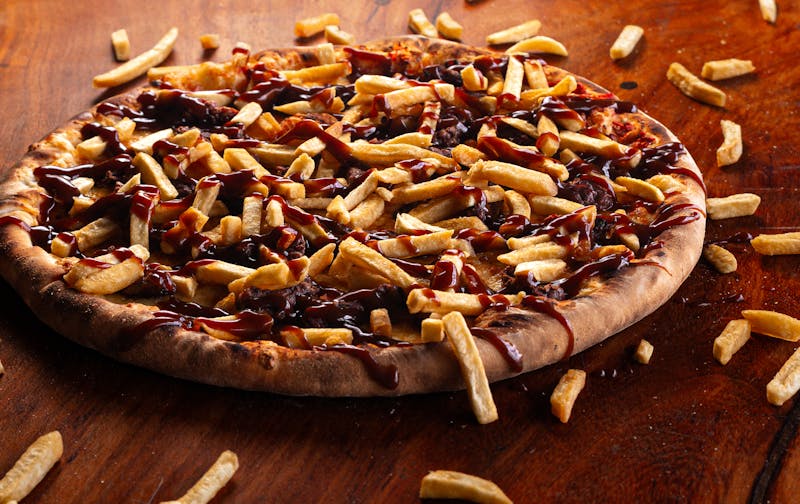 BBQ chicken pizza with caramelized onions and fresh cilantro