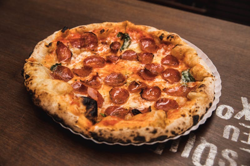 Four cheese gourmet pizza with truffle oil and arugula